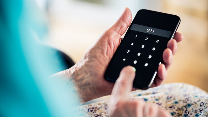 911, emergency number phone call. Old senior woman. Help from police, ambulance to hospital or paramedic. Fire, crime, heart attack or medical injury. Accident and first aid.