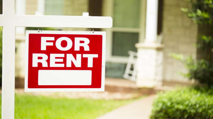 House for rent. Real estate sign. Front yard. No people.