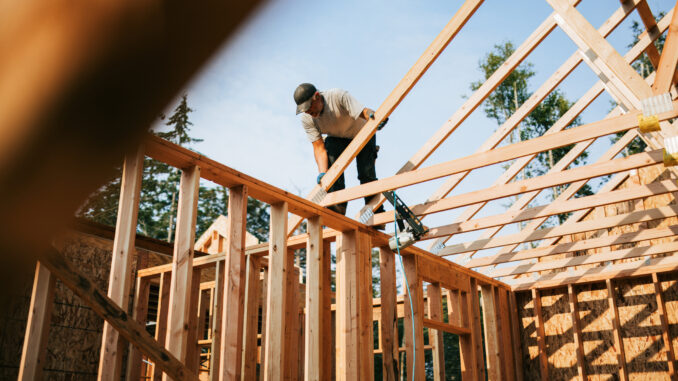 Construction Crew Putting Up Framing of New Home